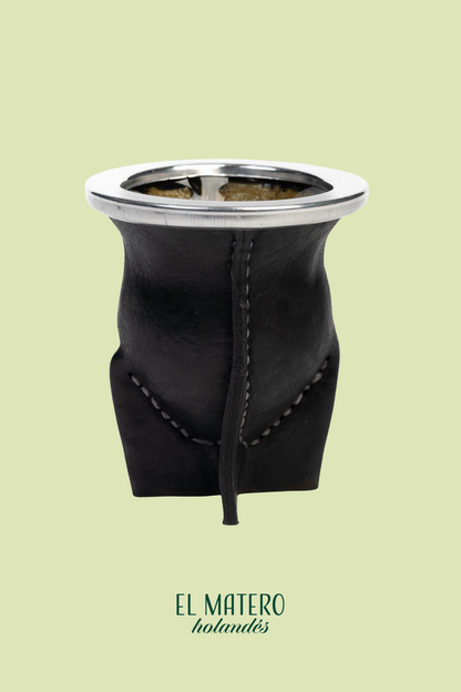 Black leather Mate with silver top on a light green background, featuring 'El Matero' branding.